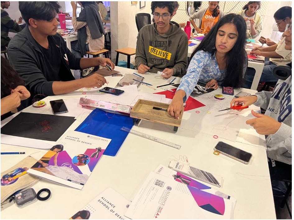 Students interactive with materials while making models during a workshop conducted by Alliance university